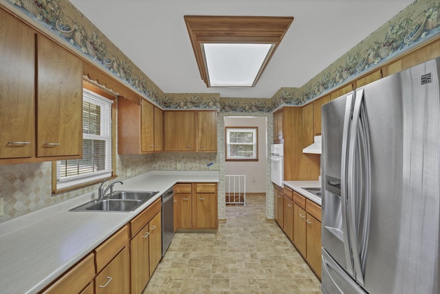 19 Kirby Rd, Heath, OH 43056 - kitchen with stainless steel appliances, light countertops, brown cabinets, and under cabinet range hood