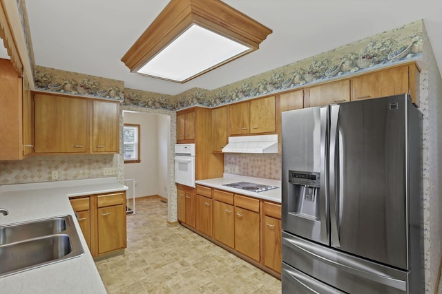 19 Kirby Rd, Heath, OH 43056 - kitchen with stainless steel fridge with ice dispenser, under cabinet range hood, white oven, light countertops, and decorative backsplash