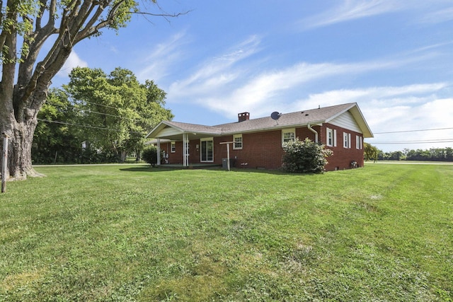 19 Kirby Rd, Heath, OH 43056 - rear view of house with brick siding, a lawn, a porch, and a chimney