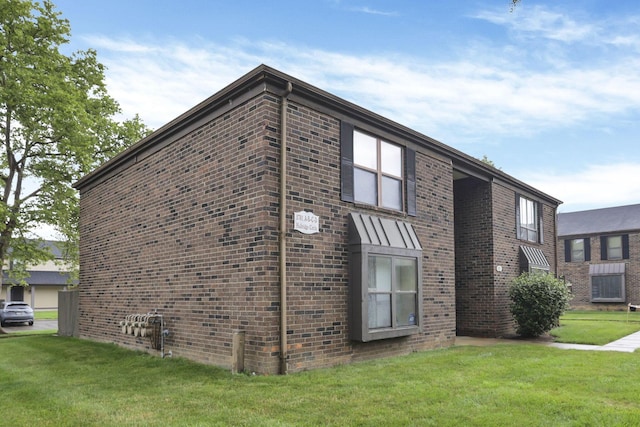 5781 Hallridge Cir Unit B, Columbus, OH 43232 - view of property exterior featuring brick siding and a yard