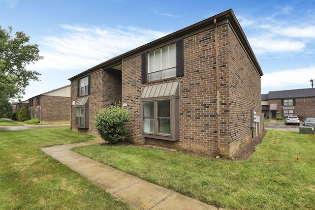 5781 Hallridge Cir Unit B, Columbus, OH 43232 - view of property exterior featuring brick siding and a lawn