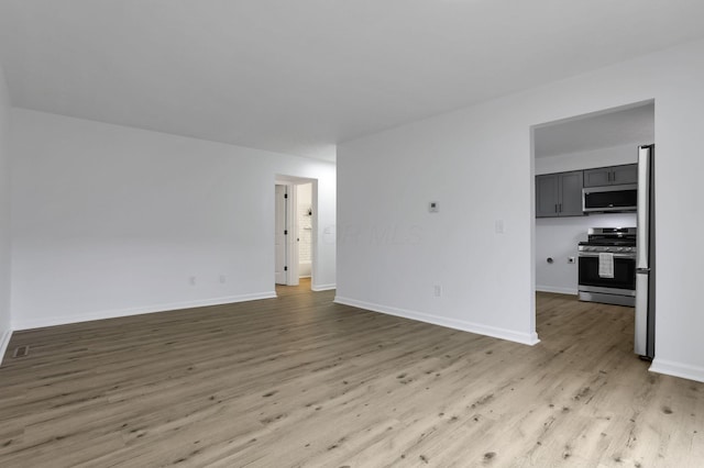 5781 Hallridge Cir Unit B, Columbus, OH 43232 - unfurnished living room with light wood finished floors and baseboards