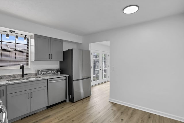 5781 Hallridge Cir Unit B, Columbus, OH 43232 - kitchen with appliances with stainless steel finishes, gray cabinetry, healthy amount of natural light, and light wood-style floors
