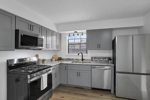 5781 Hallridge Cir Unit B, Columbus, OH 43232 - kitchen with stainless steel appliances, gray cabinets, light stone countertops, and light wood-type flooring