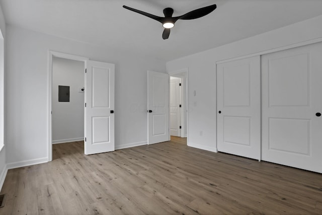 5781 Hallridge Cir Unit B, Columbus, OH 43232 - unfurnished bedroom featuring wood finished floors, electric panel, a closet, and a ceiling fan