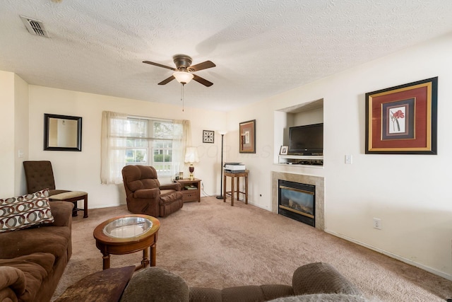 7787 Freesia St Unit 216, Blacklick, OH 43004 - living area featuring a ceiling fan, carpet flooring, a fireplace, and a textured ceiling