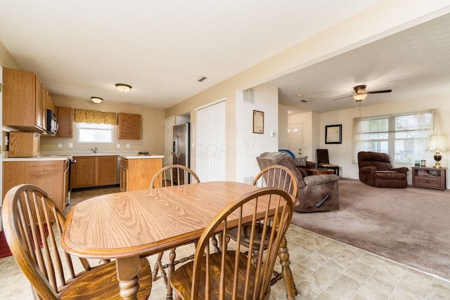 7787 Freesia St Unit 216, Blacklick, OH 43004 - dining space with light colored carpet and a ceiling fan