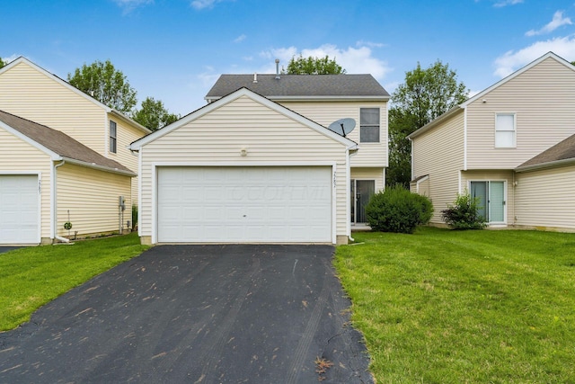 7787 Freesia St Unit 216, Blacklick, OH 43004 - view of front facade featuring a garage, an outdoor structure, a front lawn, and asphalt driveway