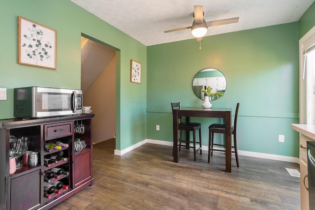 6447 Cranston Way Unit 19, Dublin, OH 43017 - dining room featuring dark wood-type flooring, a ceiling fan, and a textured ceiling