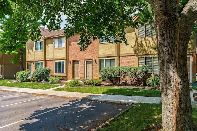 6447 Cranston Way Unit 19, Dublin, OH 43017 - view of front facade featuring uncovered parking, stucco siding, and brick siding