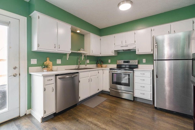 6447 Cranston Way Unit 19, Dublin, OH 43017 - kitchen with appliances with stainless steel finishes, under cabinet range hood, light countertops, and white cabinetry