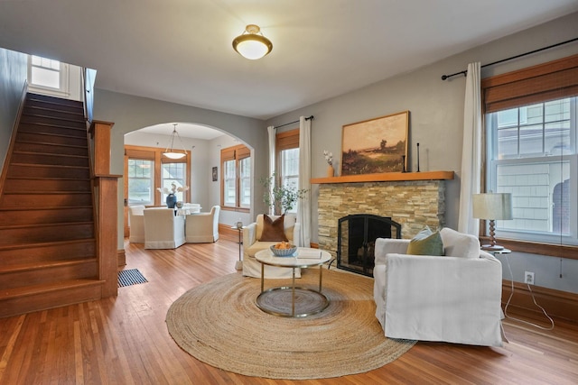 41 Northmoor Pl, Columbus, OH 43214 - living area with arched walkways, wood finished floors, a fireplace, and stairs