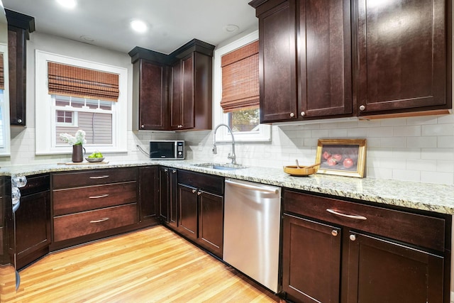 41 Northmoor Pl, Columbus, OH 43214 - kitchen featuring dishwasher, light wood-style floors, decorative backsplash, light stone countertops, and dark brown cabinets
