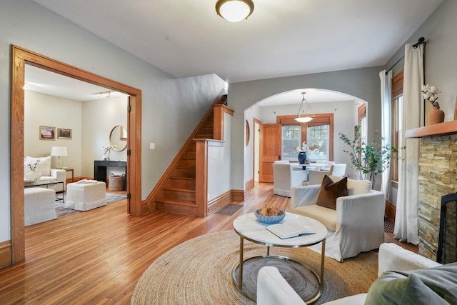 41 Northmoor Pl, Columbus, OH 43214 - living area featuring arched walkways, stairs, light wood finished floors, and a fireplace