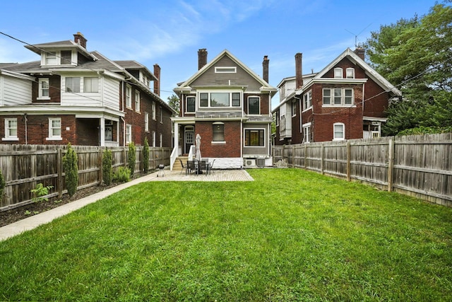 1867 Bryden Rd, Columbus, OH 43205 - rear view of house with entry steps, a patio, a fenced backyard, and brick siding