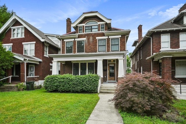 1867 Bryden Rd, Columbus, OH 43205 - view of front of home featuring brick siding, covered porch, and a front lawn