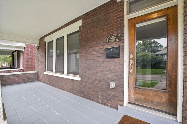 1867 Bryden Rd, Columbus, OH 43205 - view of exterior entry with a porch and brick siding