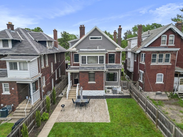 1867 Bryden Rd, Columbus, OH 43205 - back of property with brick siding, a patio, and a fenced backyard