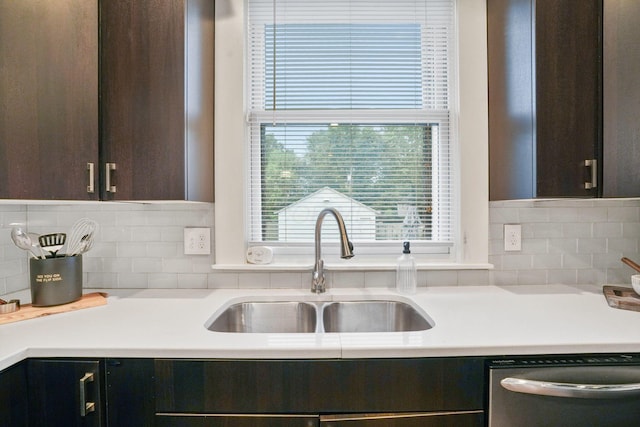 1867 Bryden Rd, Columbus, OH 43205 - kitchen featuring stainless steel dishwasher, dark brown cabinets, light countertops, and backsplash