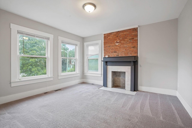 1867 Bryden Rd, Columbus, OH 43205 - unfurnished living room featuring a brick fireplace and carpet