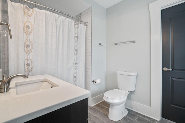 1867 Bryden Rd, Columbus, OH 43205 - full bath featuring vanity, wood tiled floors, and a shower with shower curtain