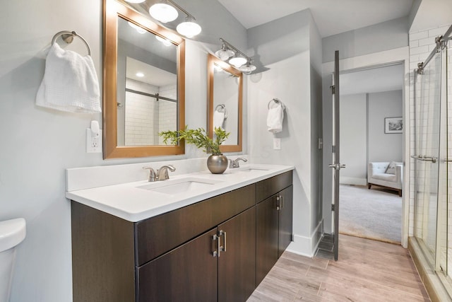 1867 Bryden Rd, Columbus, OH 43205 - full bath featuring double vanity, a tile shower, and wood finished floors