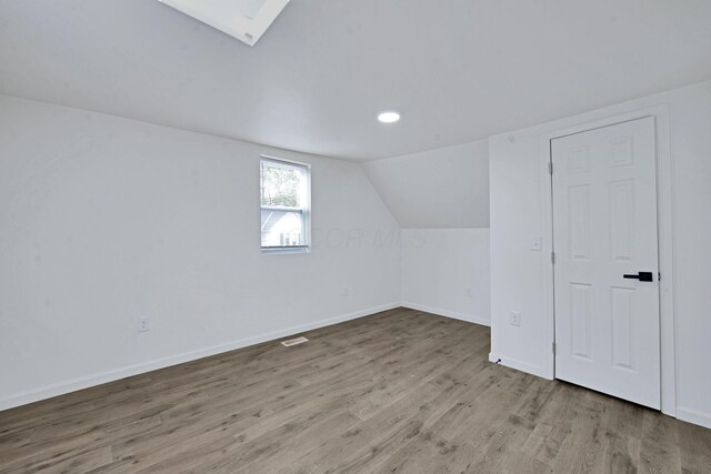 863 Carpenter St, Columbus, OH 43206 - bonus room featuring wood finished floors, vaulted ceiling, and recessed lighting