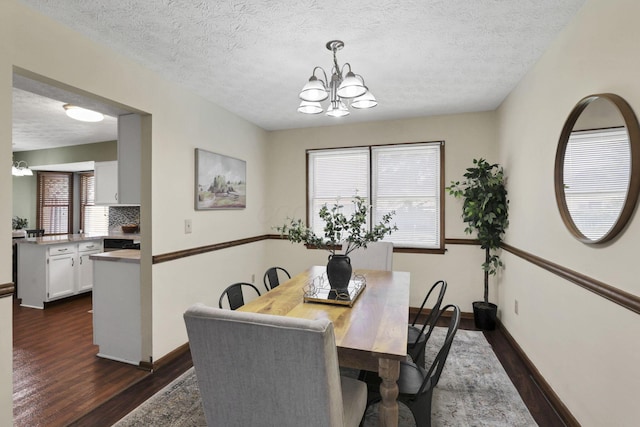 6464 Blackhaw Dr, Reynoldsburg, OH 43068 - dining space featuring dark wood-style floors, a chandelier, and a textured ceiling