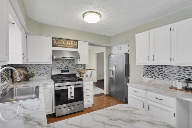 6464 Blackhaw Dr, Reynoldsburg, OH 43068 - kitchen with appliances with stainless steel finishes, wall chimney range hood, white cabinets, light stone countertops, and decorative backsplash