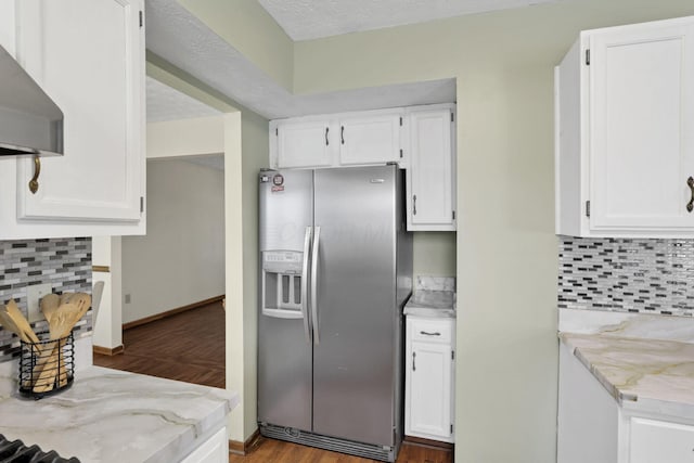 6464 Blackhaw Dr, Reynoldsburg, OH 43068 - kitchen with stainless steel refrigerator with ice dispenser, wall chimney exhaust hood, white cabinetry, and decorative backsplash
