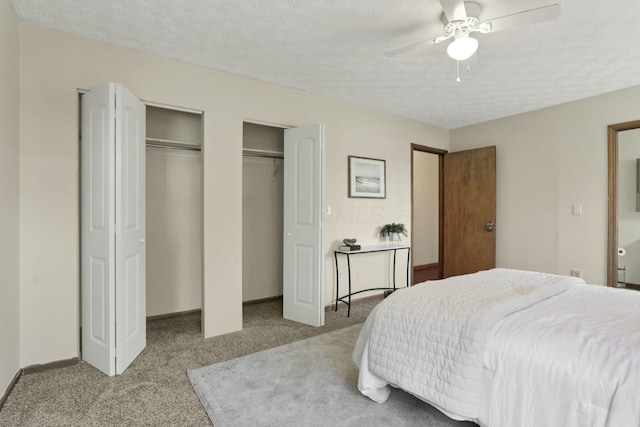 6464 Blackhaw Dr, Reynoldsburg, OH 43068 - bedroom featuring light carpet, multiple closets, a textured ceiling, and ceiling fan