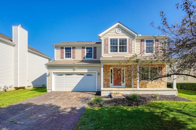 5700 Boucher Dr, Orient, OH 43146 - traditional-style house with driveway, an attached garage, covered porch, a front lawn, and stone siding