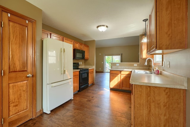 5700 Boucher Dr, Orient, OH 43146 - kitchen with black appliances, dark wood-style flooring, light countertops, and brown cabinets