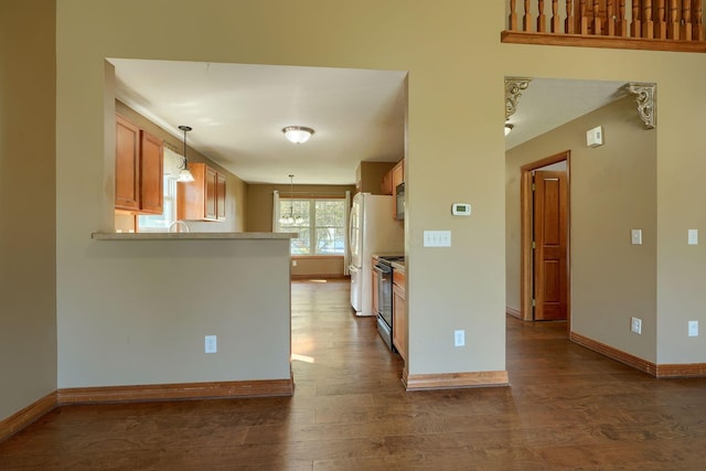 5700 Boucher Dr, Orient, OH 43146 - kitchen with dark wood finished floors, hanging light fixtures, electric range, and light countertops