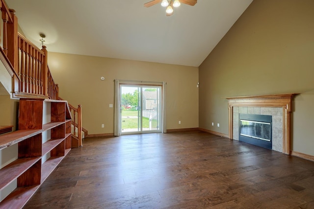 5700 Boucher Dr, Orient, OH 43146 - unfurnished living room with wood finished floors, stairs, a ceiling fan, a tiled fireplace, and high vaulted ceiling