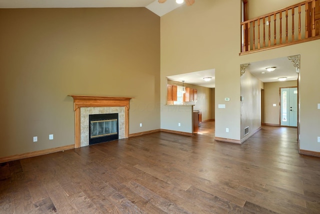 5700 Boucher Dr, Orient, OH 43146 - unfurnished living room featuring high vaulted ceiling, dark wood finished floors, and a fireplace