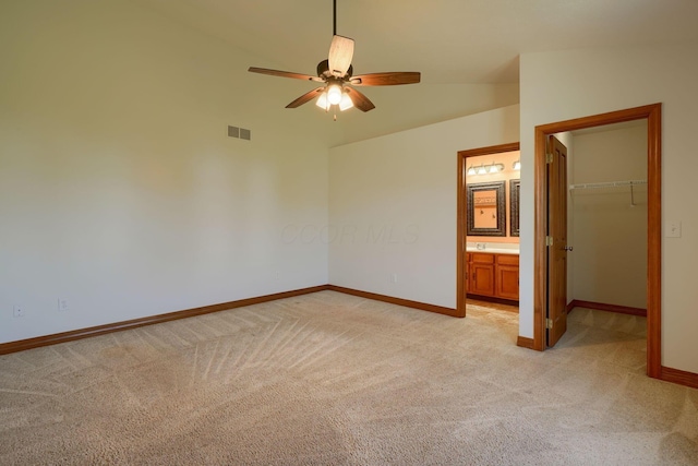 5700 Boucher Dr, Orient, OH 43146 - unfurnished bedroom with light carpet, a walk in closet, vaulted ceiling, a closet, and ensuite bathroom