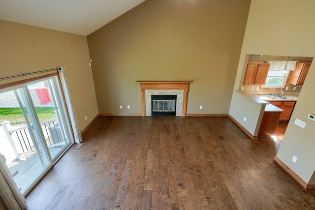 5700 Boucher Dr, Orient, OH 43146 - unfurnished living room featuring high vaulted ceiling, dark wood-style floors, and a premium fireplace