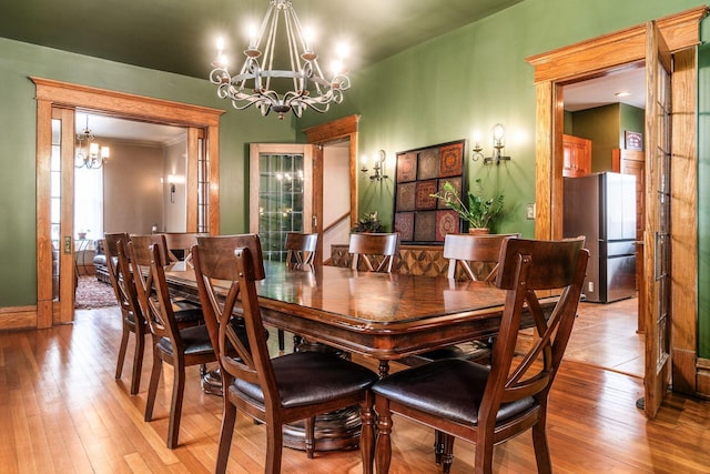 1412 Bryden Rd, Columbus, OH 43205 - dining room with a chandelier and light wood-style flooring