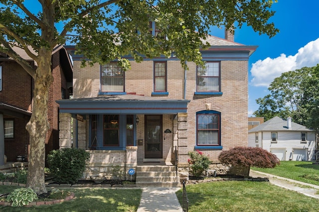 1412 Bryden Rd, Columbus, OH 43205 - american foursquare style home with brick siding, a front lawn, and a porch
