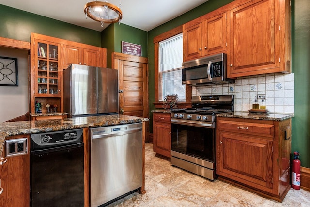 1412 Bryden Rd, Columbus, OH 43205 - kitchen featuring appliances with stainless steel finishes, backsplash, brown cabinets, and glass insert cabinets