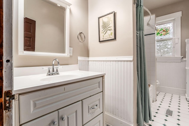 1412 Bryden Rd, Columbus, OH 43205 - bathroom with vanity, wainscoting, and curtained shower