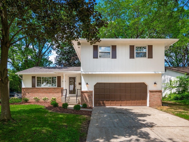 6019 Beechcroft Rd, Columbus, OH 43229 - tri-level home featuring brick siding, an attached garage, driveway, and a front yard