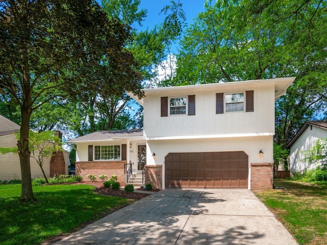 6019 Beechcroft Rd, Columbus, OH 43229 - split level home with brick siding, a garage, concrete driveway, and a front lawn