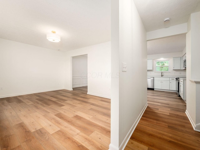 6019 Beechcroft Rd, Columbus, OH 43229 - hallway with light wood-style floors and a textured ceiling