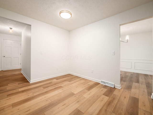 6019 Beechcroft Rd, Columbus, OH 43229 - empty room with light wood-style floors and a textured ceiling