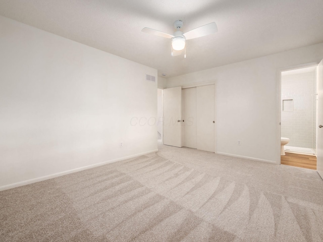 6019 Beechcroft Rd, Columbus, OH 43229 - unfurnished bedroom featuring light carpet, a closet, connected bathroom, and ceiling fan