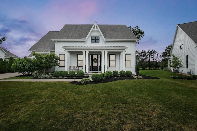 7211 Craigens Ct, Plain City, OH 43064 - view of front facade featuring a porch, a standing seam roof, a front lawn, roof with shingles, and a metal roof