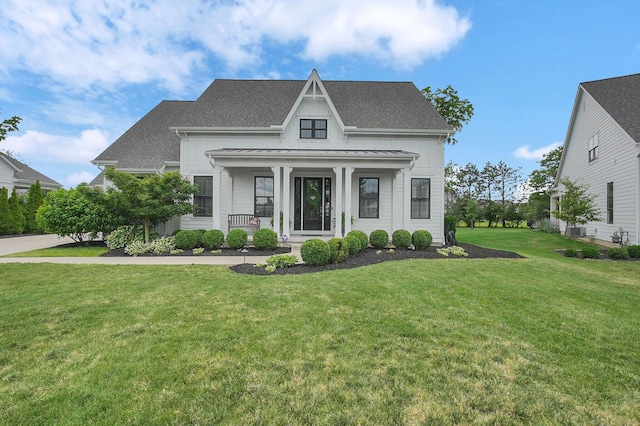 7211 Craigens Ct, Plain City, OH 43064 - view of front of home featuring a standing seam roof, a porch, a front lawn, a metal roof, and roof with shingles