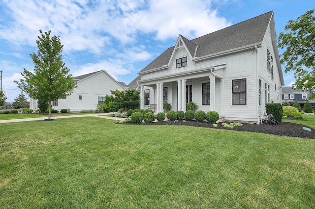 7211 Craigens Ct, Plain City, OH 43064 - view of front of home featuring board and batten siding, a front lawn, a shingled roof, and covered porch